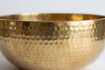 Close-up of Golden Hammered Metal Bowl Surface Texture
