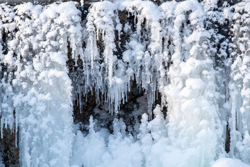 Frozen waterfall detail with snow and icicles
