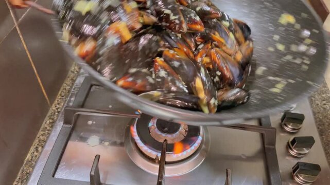 Saut&eacute;ed garlic and butter mussels in woke, Mahe Seychelles 25fps 003
