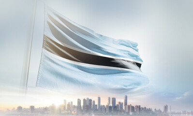 Botswana flag waving with modern futuristic buildings. Botswana national flag beautifully waving in the sky.