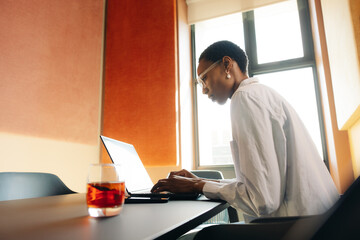 Focused professional working on laptop in contemporary office environment