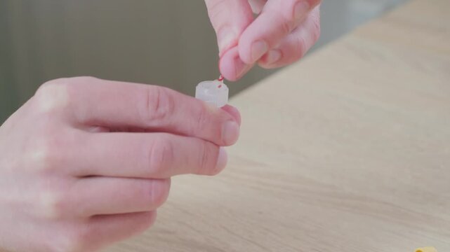 man pricks finger for blood rapid diagnostic at-home test, showcasing convenience and accessibility self-administered medical testing, finger prick test, small intestine diseases, health check