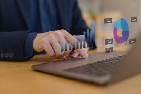 Businessman analyzing growth charts and data dashboard on laptop. Concept of business analytics, performance tracking, financial analysis, KPI monitoring, data visualization and strategic decision mak - Powered by Adobe