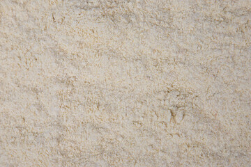 Ground fenugreek as a background or texture. Top view.