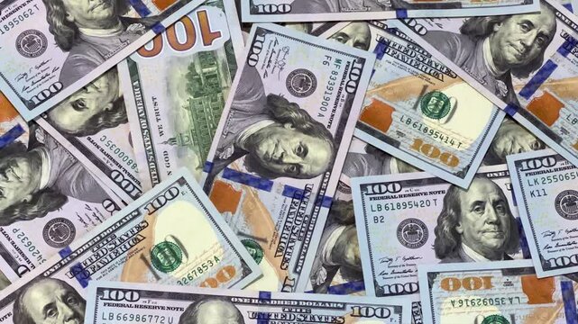 Background with American hundred-dollar bills. Close-up of 100-dollar bills. Money, US banknotes. Background with money. Many dollar bills on a table. 4К
