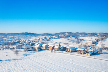 Winter in Croatia. Village of Belavici under snow, idyllic rural winter landscape.