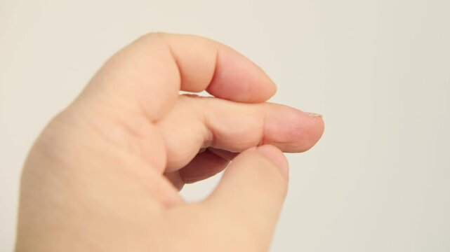 Closeup female hand, Compulsive nail and cuticle biting, Stress relief or self-harm, obsessive-compulsive disorder, mental health, domestic violence, victim support, psychological trauma