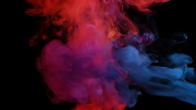 Red and blue ink mixing in water creating abstract patterns on a black background.