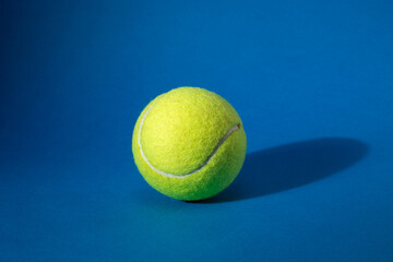 Close-up on a Tennis Ball isolated on blue background