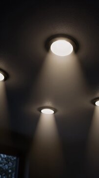 Three recessed ceiling lights illuminate a dark room, creating a cozy and modern ambiance.