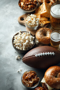 American football game day spread with beer, popcorn, cheese, and snacks