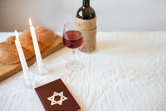 Shabbat Shalom template. Challah bread, red kosher wine, book and candles
