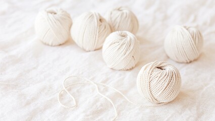 Soft White Yarn Balls on Cozy Fabric Background, Minimal Handmade Concept