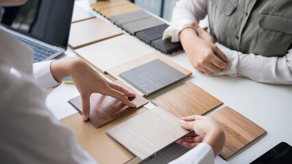 Design Team Reviewing Wooden Texture Samples at Creative Workspace