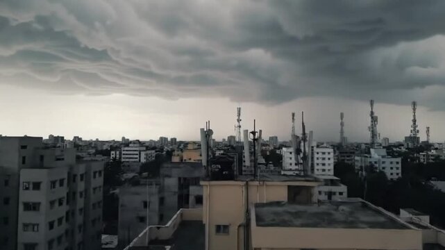 A dramatic and foreboding scene unfolds over a bustling urban landscape as dark, wavy mammatus clouds dominate the sky. The undulating cloud formations, indicative of an impending storm or turbulent w