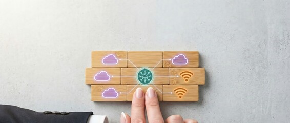 Business person connecting cloud and wifi icons on wooden blocks, technology concept