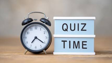 Matte black alarm clock beside pale-blue quiz time board on warm-gray platform, showcasing a playful and engaging study atmosphere