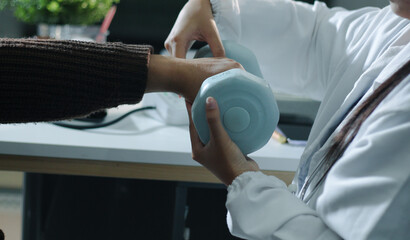 doctor is checking for muscle injuries and using dumbbells test injury and also help with physical therapy strengthen muscles because physical therapy will help strengthen muscles and help blood flow