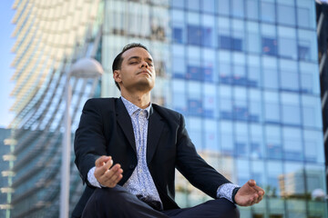 Latin businessman practicing mindfulness meditation outdoors