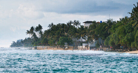 Unawatuna Beach Coastal Panorama with Palm Trees and Stone Structures