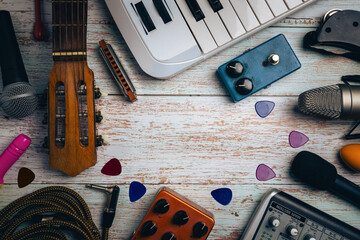 Music instruments flat lay on wooden background with copy space