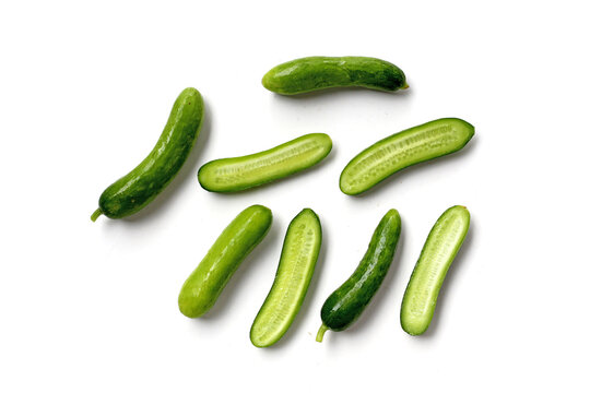 Fresh mini baby cucumbers on white background