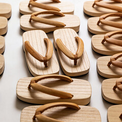 Wooden flip-flops arranged neatly on a white background  