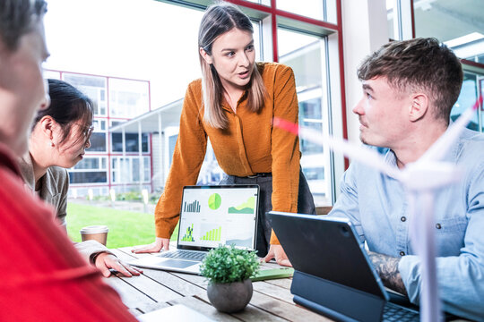 Teamwork and discussion in a modern office with focus on sustainability