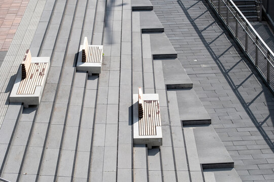 Urban minimalism stairs steps on concrete terrace with bench geometry lines and shadow creating calm architectural progress metaphor