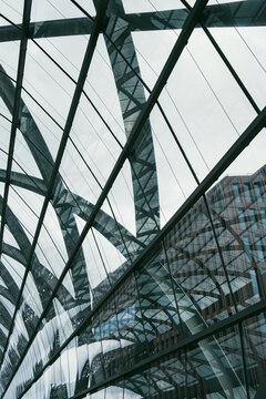 Close up facade glass curved skyscraper with steel lines modern architecture reflection and pattern creating minimalist futuristic urban background