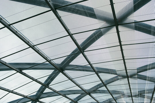 Wide view glass roof structure grid with steel modern architecture geometric reflection under skylight for minimal futuristic abstract background