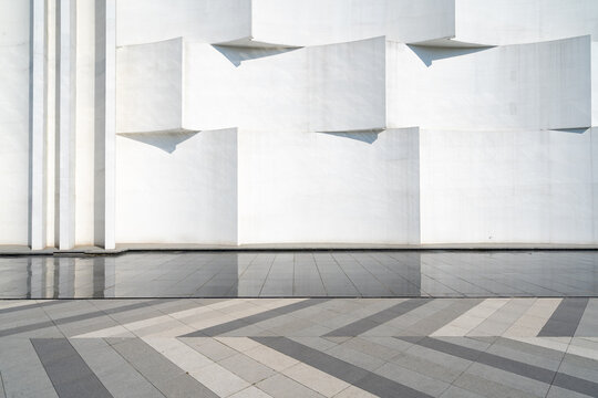 Minimalist white geometric architecture with tiled floor