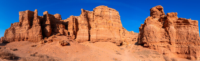 Fototapeta premium Charyn Canyon, Valley of Castles. The excellence of Kazakhstan. Panorama of natural unusual landscape. The red canyon of extraordinary beauty looks like a Martian landscape.