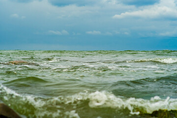 A panorama of sea waves and sky stretching to the horizon. Lightly choppy sea. Warm water in summer.