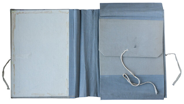 Open vintage blue cloth bound folder with inner paper pocket and string tie on white background