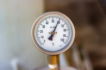 Close up of an Industrial Temperature Gauge Displaying a Precise Reading of 65 Degrees Celsius