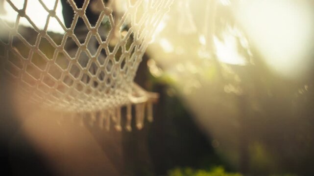 Close-up of hammock swaying in warm island breeze