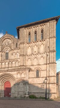 Eglise Abbatiale Sainte-Croix timelapse hyperlapse in Bordeaux, France, Romanesque Catholic church with a medieval facade. Landmark showcases rich architectural and cultural heritage under a blue sky