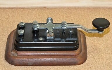 Vintage telegraph key transmitting Morse code message