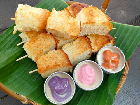 Slice steamed bread with colorful Thai custard dipping. Traditional Thai sweet snack.