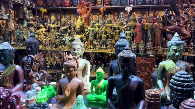 CAMBODIA - October 2, 2025: Many different souvenirs at the street market in Siem Reap. Amulets at the old souvenir market "Psah Chas, Psar Chas, Psar Chaa". Buddha statues. Handicrafts. 4К