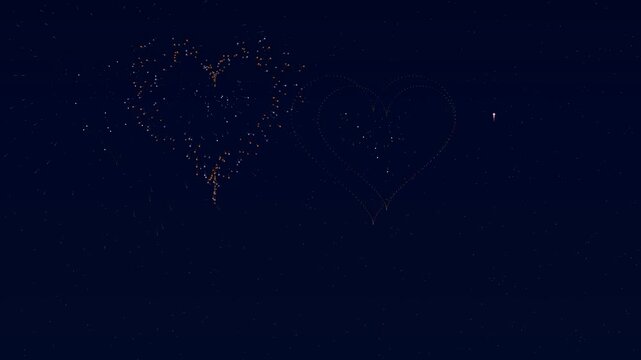 Fireworks light up the night sky in heart shapes to celebrate Valentines day. People enjoy the colorful display during a festive moment of love and joy in the air