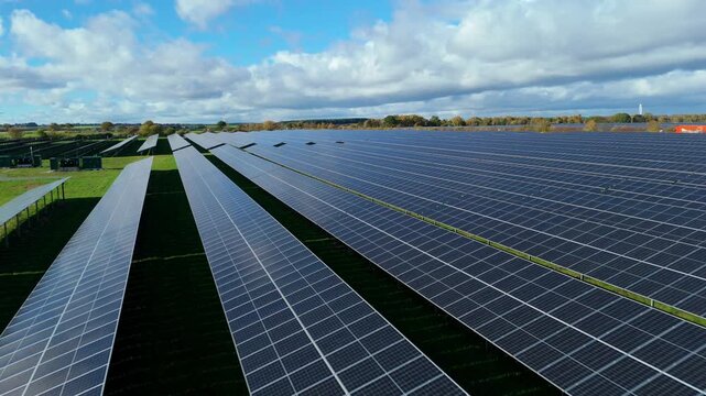 Drone aerial view of modern solar power facility contributing clean energy to the National Grid and reducing carbon impact in Britain