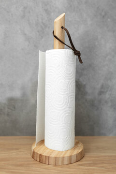 Role of paper towel on modern wooden support in the kitchen.