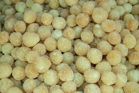 Danadar tightly packed, pale golden yellow Laddu homemade sweet