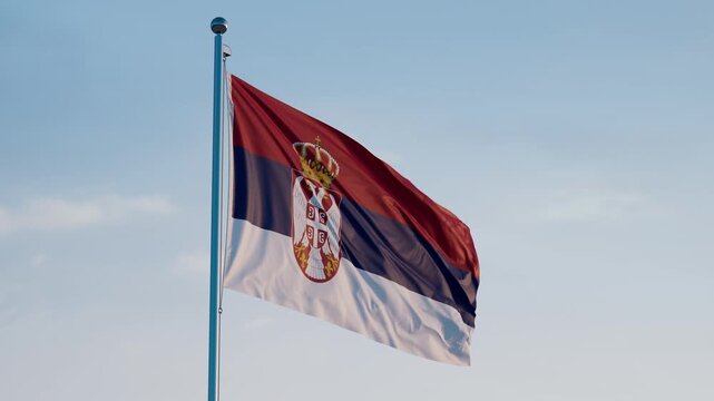 Serbia, Belgrade: Cinematic Waving National Flag Against Blue Sky