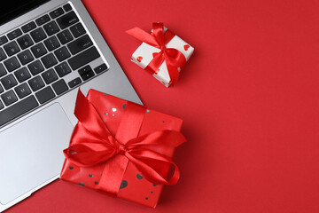 Gift box and laptop on office desk table. Top view flat lay with blank greeting card for your...