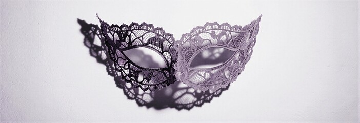 Elegant lace mask with intricate shadows on white background