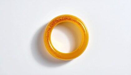 Golden ring with speckled details on white surface