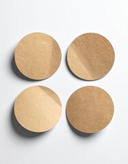 Four circular paper pieces sit atop a white surface